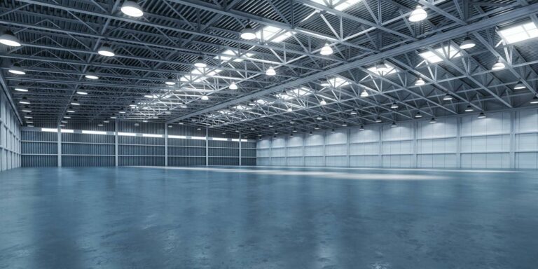 Spacious, well-lit industrial-metal warehouse interior.