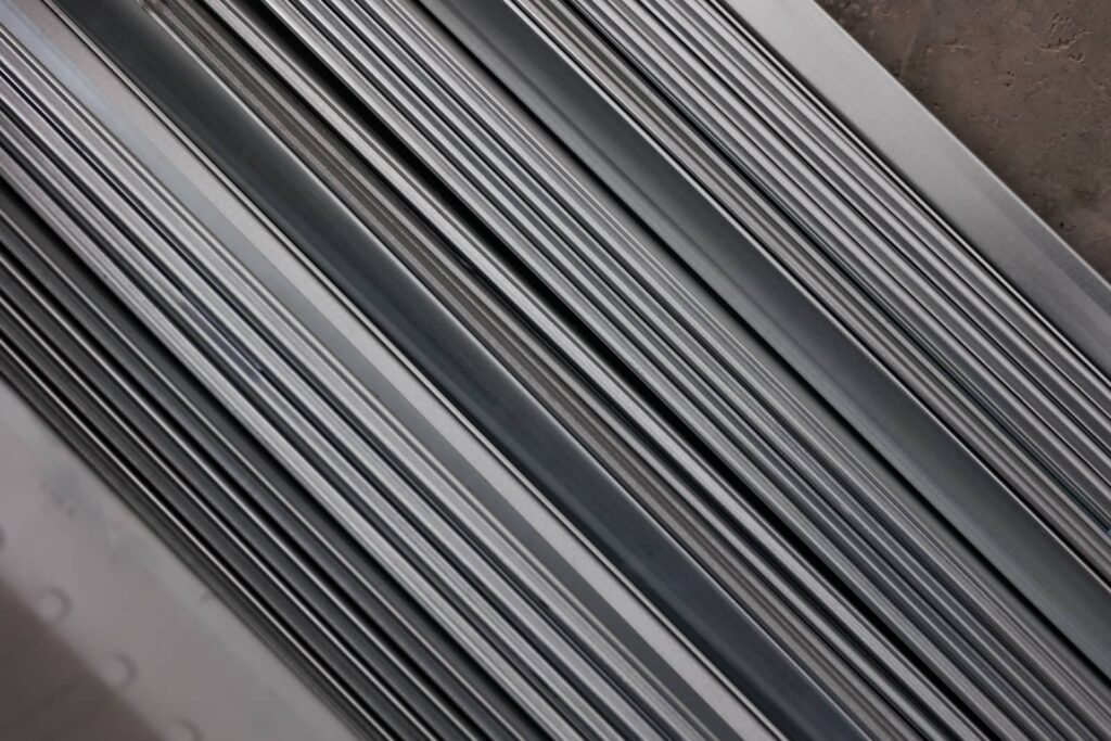 Stacked metal slats or rails in a diagonal close-up.