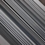 Stacked metal slats or rails in a diagonal close-up.