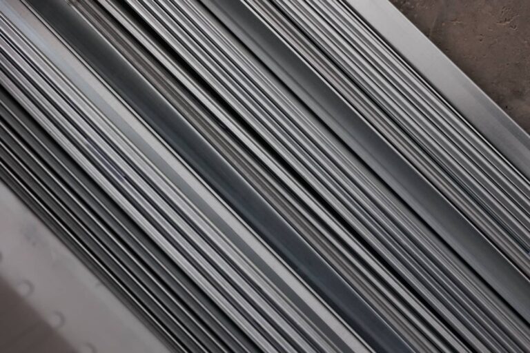 Stacked metal slats or rails in a diagonal close-up.