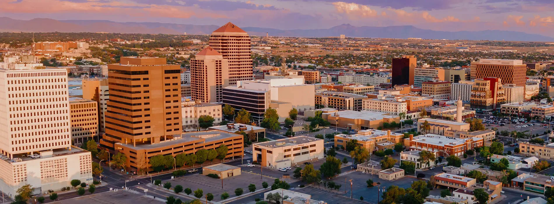 New Mexico metal buildings near the Albuquerque skyline at sunset