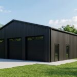 Black metal garage building on a grassy lot.