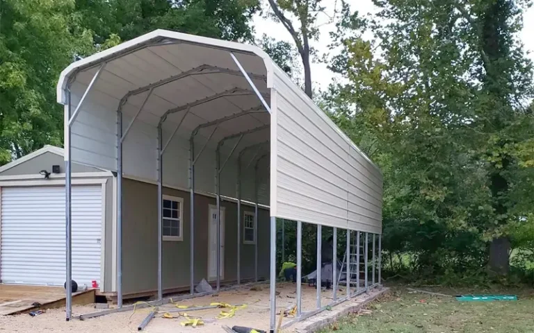 Custom metal RV cover installed over a travel trailer